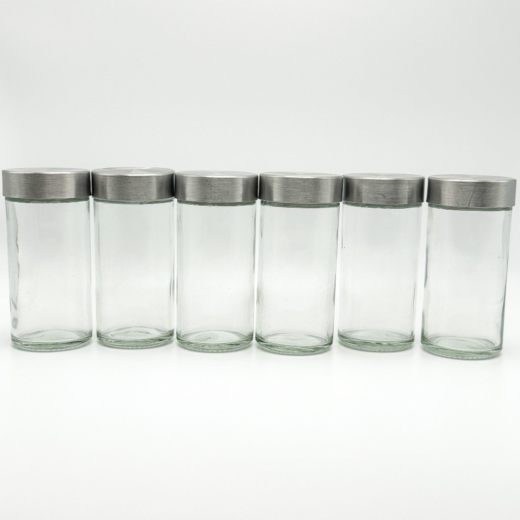 JUV Juicing Bottles aligned in a straight line with the caps on the bottles