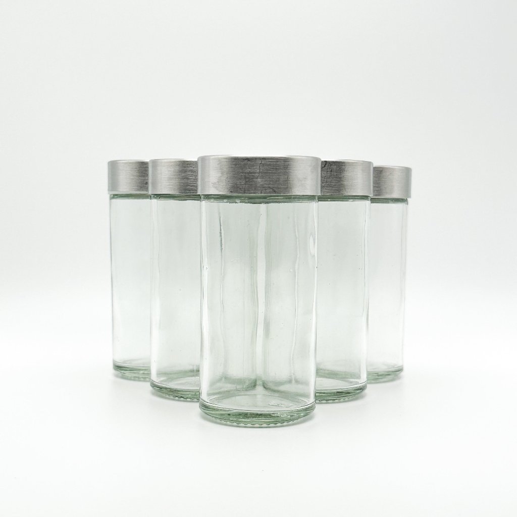 JUV juicing bottles aligned in a triangle formation with white background