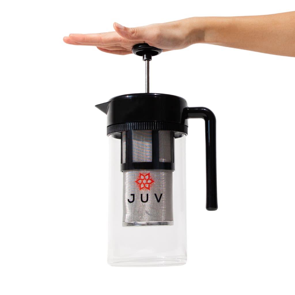 JUV Press with open hand pressing down on top handle on white background